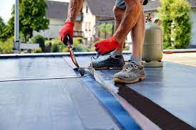 Roofer fixing flat roof